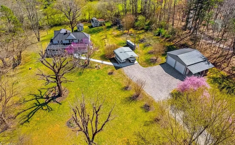 Beautiful setting with a long tree-lined driveway! Over three acres in NC. $249,900