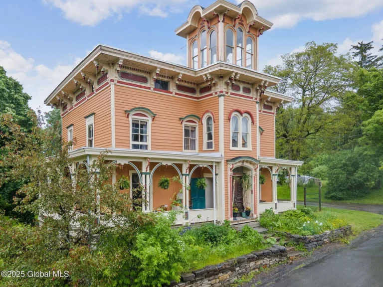 Check out that staircase! Incredible wrap-around porch in New York. $275,000.