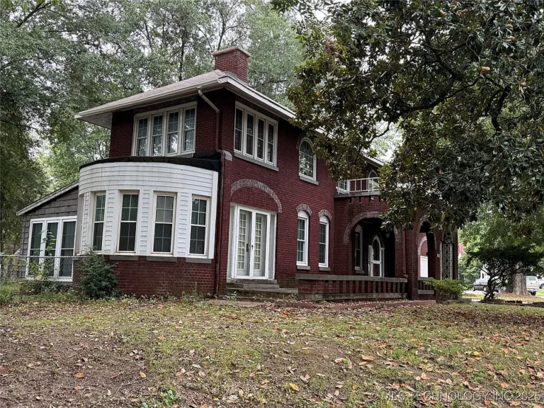 Pretty porch! C. 1945 charm with three fireplaces in Muskogee. $250,000.