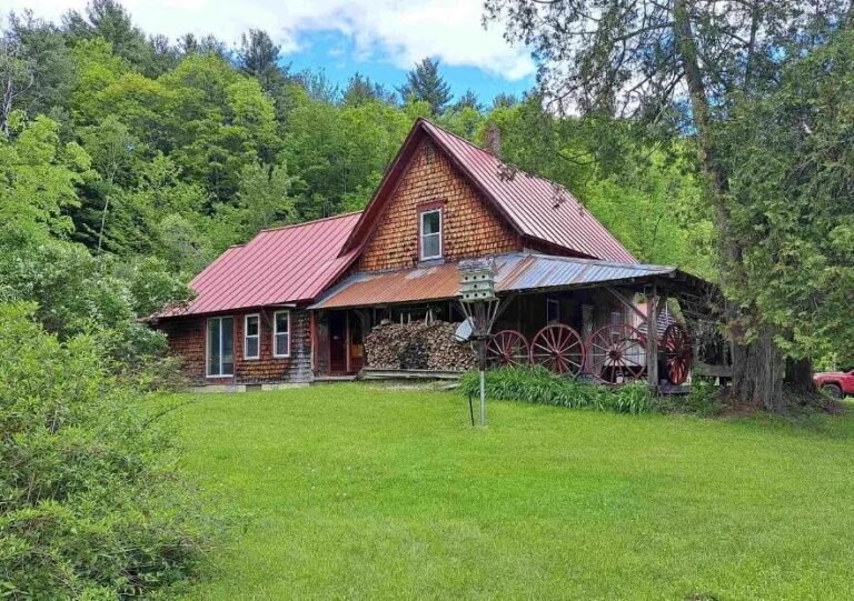 $395,000. Pretty exterior and a huge kitchen! On 27 acres in New Hampshire.